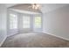 Spacious bedroom featuring vaulted ceiling, neutral carpet and three windows at 4915 Truitt Ln, Decatur, GA 30035