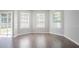 Bright breakfast nook with wood floors, a trio of windows and door for natural light and views at 4915 Truitt Ln, Decatur, GA 30035