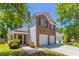 Inviting home showcasing a brick facade, lush landscaping, a two-car garage, and a charming entrance at 4915 Truitt Ln, Decatur, GA 30035