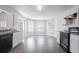 Bright kitchen features modern appliances, white cabinets, and hardwood style flooring at 4915 Truitt Ln, Decatur, GA 30035