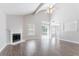 Bright living room features vaulted ceiling, a fireplace, wood floors and sliding glass doors leading to the backyard at 4915 Truitt Ln, Decatur, GA 30035