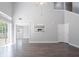 Open living room featuring wood floors, light paint, access to the kitchen and dining area, and a sliding glass door at 4915 Truitt Ln, Decatur, GA 30035