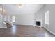 Living room features neutral paint, wood floors, a corner fireplace, and large windows for natural light at 4915 Truitt Ln, Decatur, GA 30035
