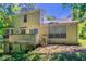 Back exterior of home showing wooden deck and lots of green foliage at 1076 Plantation Se Blvd, Conyers, GA 30094