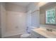 Bathroom with a tub/shower combination, white tile, and a vanity with a sink at 1076 Plantation Se Blvd, Conyers, GA 30094