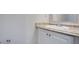 Well-lit bathroom with a single sink vanity featuring updated hardware at 1076 Plantation Se Blvd, Conyers, GA 30094