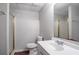 Bathroom featuring a single vanity sink, framed mirror, shower and tub combination with glass door at 1076 Plantation Se Blvd, Conyers, GA 30094