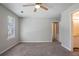 Bedroom featuring carpet, a window with blinds, and en suite bath at 1076 Plantation Se Blvd, Conyers, GA 30094