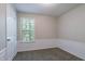 Bedroom featuring carpet, white door, and trim beneath a window with blinds at 1076 Plantation Se Blvd, Conyers, GA 30094