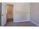 Bedroom featuring neutral walls, an open door, carpeted floor, and white trim at 1076 Plantation Se Blvd, Conyers, GA 30094