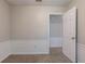 Bedroom featuring carpet, white door, and trim beneath a window at 1076 Plantation Se Blvd, Conyers, GA 30094