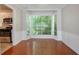 Cozy dining nook with bay window provides ample natural light and features hardwood floors and wainscoting at 1076 Plantation Se Blvd, Conyers, GA 30094