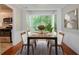 Dining area featuring bay window next to kitchen, and dining table set at 1076 Plantation Se Blvd, Conyers, GA 30094