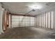 Empty garage with a partially open garage door at 1076 Plantation Se Blvd, Conyers, GA 30094