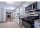 An updated kitchen with stainless steel appliances, countertops and seamless flow to living area at 1076 Plantation Se Blvd, Conyers, GA 30094