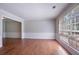 Bright living room featuring hardwood floors, fresh paint, wainscoting, and large windows at 1076 Plantation Se Blvd, Conyers, GA 30094
