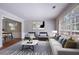 Living room is furnished with modern decor and has large windows at 1076 Plantation Se Blvd, Conyers, GA 30094