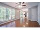 Open living room with hardwood floors and large windows looking out to the greenery at 1076 Plantation Se Blvd, Conyers, GA 30094