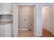 Utility room featuring white cabinets, tile flooring, and a laundry hookup at 1076 Plantation Se Blvd, Conyers, GA 30094