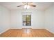 Bright bedroom featuring wood floors, a ceiling fan, and a large window offering natural light at 205 Tuxworth Cir # 205, Decatur, GA 30033