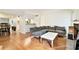 Open-concept living room with hardwood floors, modern sofa, and a view into the adjacent dining and kitchen areas at 205 Tuxworth Cir # 205, Decatur, GA 30033