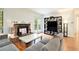 Inviting living room featuring a brick fireplace, wood flooring, and a modern bookcase at 205 Tuxworth Cir # 205, Decatur, GA 30033