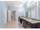 Spacious bathroom featuring a large vanity with double sinks, granite countertop, and tile flooring at 4625 Cold Spring Court, Cumming, GA 30041