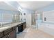 Bright bathroom with double vanity, separate shower and soaking tub, and tile floors at 4625 Cold Spring Court, Cumming, GA 30041
