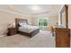Large bedroom with tray ceiling, carpet, and natural light at 4625 Cold Spring Court, Cumming, GA 30041
