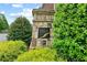 Stone entrance to James Creek neighborhood with lush landscaping and well-maintained grounds under a bright blue partly cloudy sky at 4625 Cold Spring Court, Cumming, GA 30041