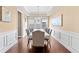Elegant dining room features tray ceiling, wainscoting, and a modern chandelier at 4625 Cold Spring Court, Cumming, GA 30041