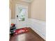 Neat foyer entry featuring paneled walls and beautiful hardwood floors at 4625 Cold Spring Court, Cumming, GA 30041