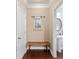 Hallway featuring a decorative bench, mirror and access to the powder room at 4625 Cold Spring Court, Cumming, GA 30041