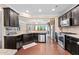 Modern kitchen with granite countertops, stainless steel appliances, and dark wood cabinetry at 4625 Cold Spring Court, Cumming, GA 30041