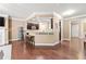 Open concept kitchen features stainless steel appliances and bar seating that looks to the living room at 4625 Cold Spring Court, Cumming, GA 30041