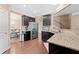 Modern kitchen features granite countertops and stainless steel appliances with a view into the dining room at 4625 Cold Spring Court, Cumming, GA 30041