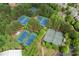 Community aerial shot showcasing multiple well-maintained tennis courts surrounded by lush greenery at 4625 Cold Spring Court, Cumming, GA 30041