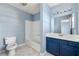 Bathroom featuring a tub-shower combo, toilet, and blue vanity with a white countertop at 2465 Brianna Dr, Hampton, GA 30228