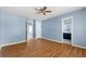 Bedroom with hardwood floors and blue walls, with an attached bathroom and walk-in closet at 2465 Brianna Dr, Hampton, GA 30228