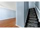 Bright entryway featuring wood floors and staircase with carpet at 2465 Brianna Dr, Hampton, GA 30228