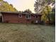 View of the brick exterior with windows and backyard including a satellite dish at 3213 Jamaica Nw Rd, Atlanta, GA 30318