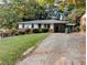 Charming single-story home with a covered carport and a well-maintained front yard at 3213 Jamaica Nw Rd, Atlanta, GA 30318