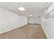 Unfinished basement features tile floors, white walls, and an exit door at 4590 Sims Ct, Tucker, GA 30084