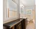 Bathroom featuring a large mirror, vanity, tub, and patterned tile floors at 4590 Sims Ct, Tucker, GA 30084
