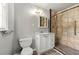 Neutral bathroom featuring a tiled shower with a grab bar and a white vanity at 4590 Sims Ct, Tucker, GA 30084