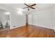 Spacious bedroom featuring hardwood floors, a ceiling fan, and a walk-in closet at 4590 Sims Ct, Tucker, GA 30084