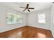 Bedroom featuring hardwood floors, a ceiling fan, and two windows for lots of natural light at 4590 Sims Ct, Tucker, GA 30084