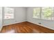 Bedroom featuring hardwood floors and two windows for lots of natural light at 4590 Sims Ct, Tucker, GA 30084