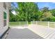Wide deck with white railing overlooks backyard with mature trees, ready for outdoor entertainment and relaxation at 4590 Sims Ct, Tucker, GA 30084