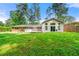 Spacious backyard showcasing a well-maintained lawn, beautiful patio, and the back of the house at 4590 Sims Ct, Tucker, GA 30084